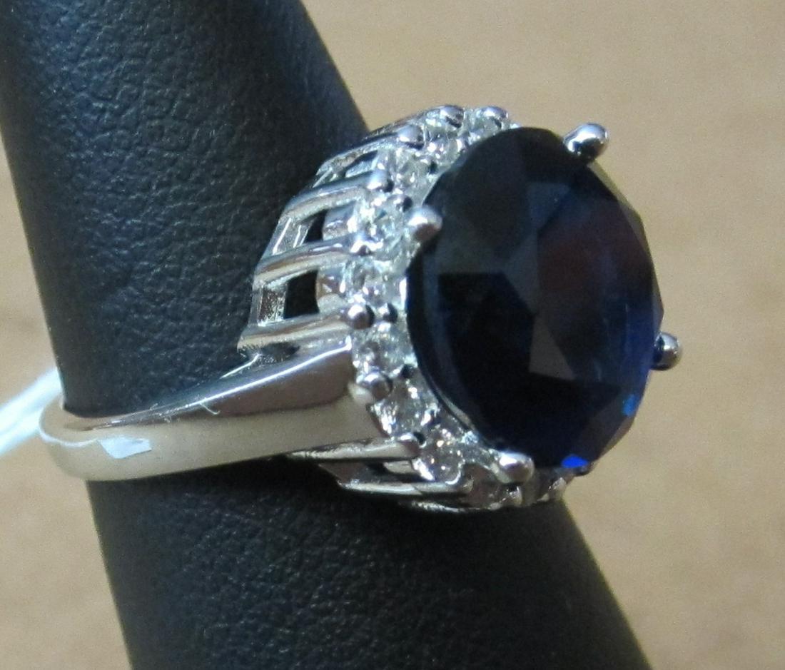 7 ct blue sapphire, lab created sterling ring: 7 ct blue sapphire, lab created sterling ring with white topaz surounding. Marked 925 size 5 1/2