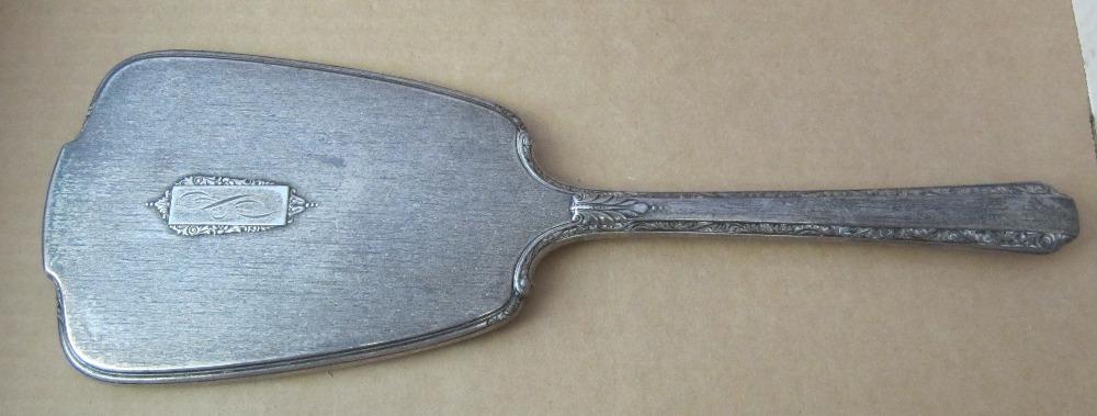 Beautiful Art Deco sterling hand mirror: Beautiful Art Deco sterling hand mirror. Beveled mirror in good condition as shown. Marked sterling on front. Has not been polished in original condition. Measures 12 1/2 inches tall. Good Condition, 