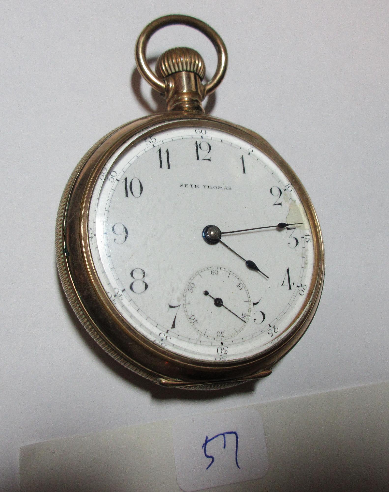 Seth Thomas gold filled pocket watch: Seth Thomas gold filled pocket watch. Porcelain dial. Has small damage between the 2 and 3 as shown in photo. Lever set. Not running. Ser.no. 624508 /case neasyres 2 1/8 inches