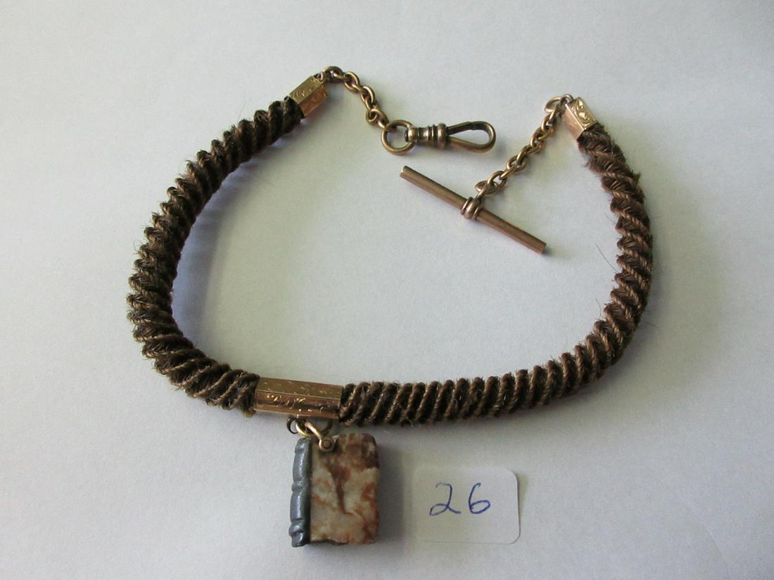 Victorian braided hair and gold filled watch fob with: Victorian braided hair and gold filled watch fob with book. 1870 - 1895. Measures 13".