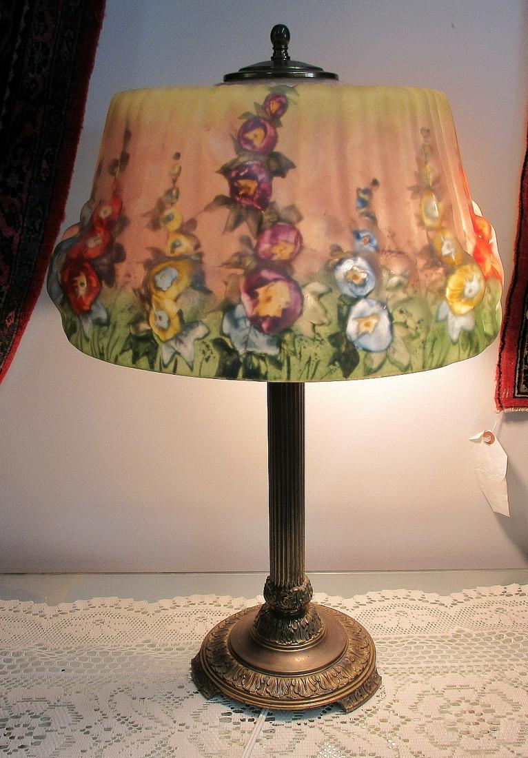 Beautiful reverse painted Pairpoint Puffy Hollyhock: Beautiful reverse painted Pairpoint Puffy Hollyhock lamp with vibrant colors with floral decoration. Great quality and detail. 21 ½ inches high and 14 inches shade. Replaced light sockets.