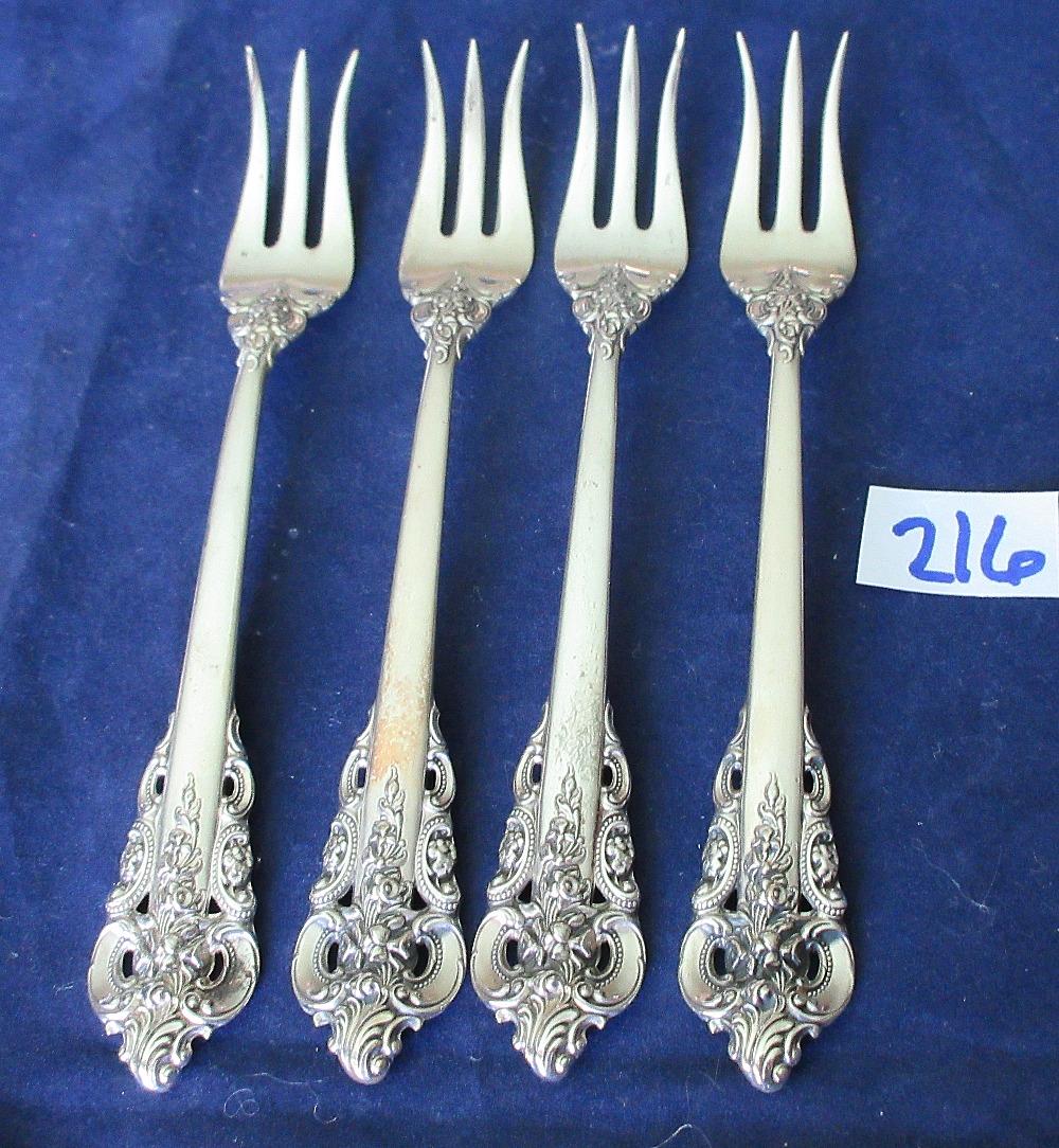 4 Wallace Grande Baroque sterling silver cocktail forks: 4 Wallace Grande Baroque sterling silver cocktail forks. 5 1/2" long. Approx. 100 grams