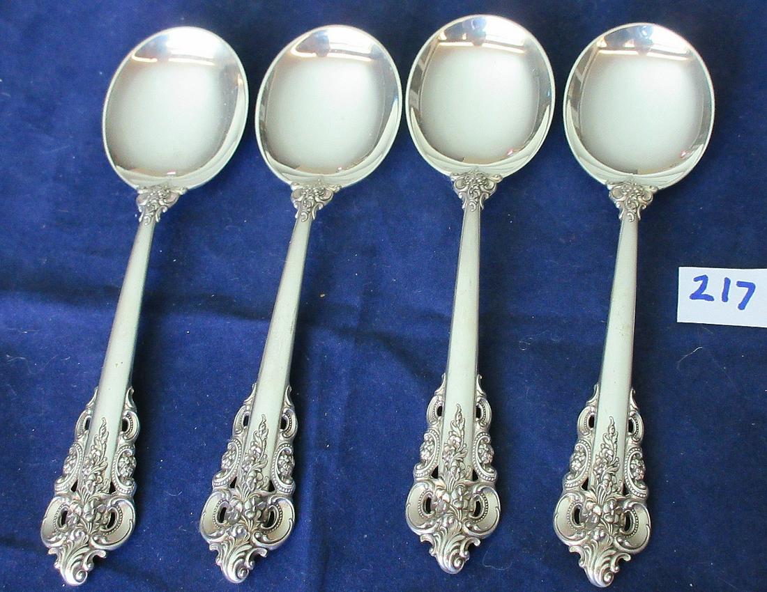 4 Wallace Grande Baroque sterling silver soup spoons: 4 Wallace Grande Baroque sterling silver soup spoons. 6 1/8". Approx. 180 grams.