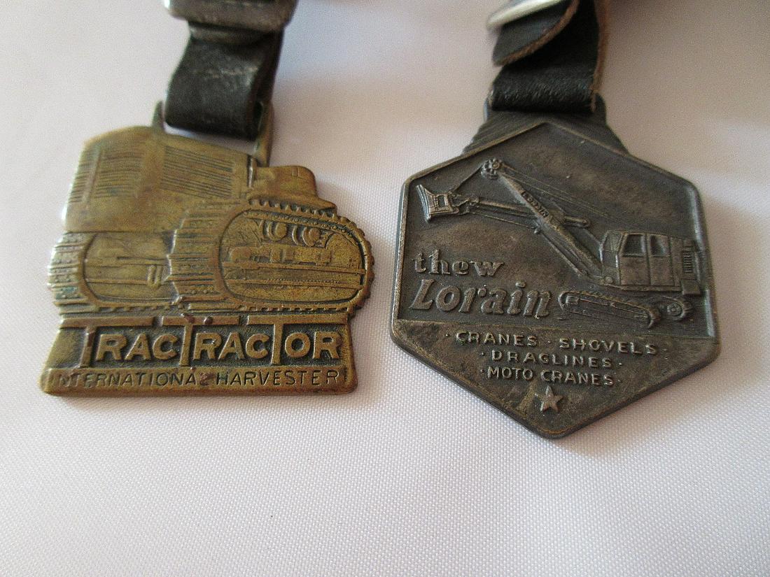 Hard to find heavy equipment advertising watch fobs.: Hard to find heavy equipment advertising watch fobs. International Harvester Tractor and Lorain Cranes and Shovels.