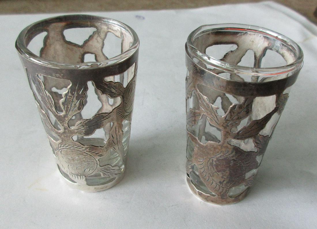 2 decorated sterling with glass insert shot glasses: 2 decorated sterling with glass insert shot glasses. In good original as found condition. Great quality And detail. Marked on bottom as shown. Measures 2 3/8