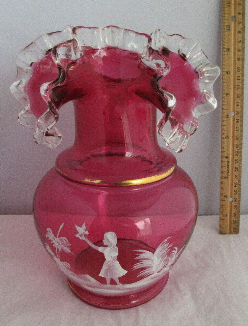 WONDERFUL MARY GREGORY CRANBERRY ART GLASS VASE: WONDERFUL MARY GREGORY CRANBERRY ART GLASS VASE WITH HAND PAINTED CHILD AND BUTTERFLY. HAND MADE.IN GOOD ORIGINAL AS FOUND CONDITION. BEAUTIFUL COLOR AND DETAIL. HAND MADE. 10 INCHS TALL. DATES 1890'S