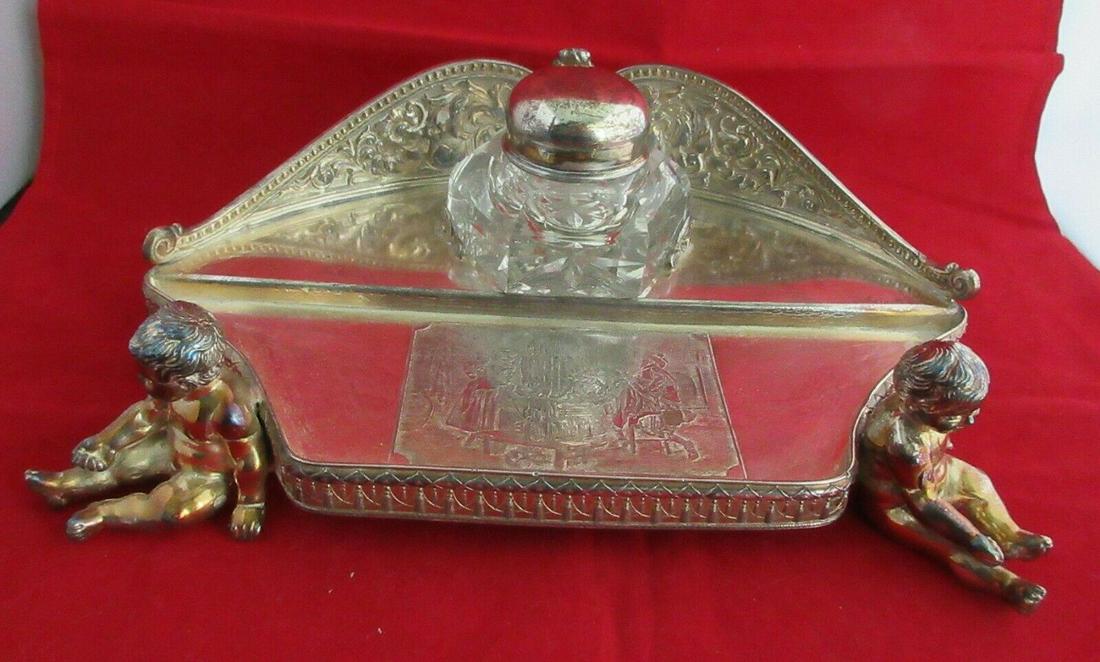 FANCY VICTORIAN INKWELL WITH CUPIDS: FANCY VICTORIAN INKWELL WITH CUPIDS. IN GOOD ORIGINAL AS FOUND CONDITION. MARKED ON BOTTOM AS SHOWN. FORBES SILVER PLATE. GREAT QUALITY AND DETAIL. 3 INCHS TALL. AND 9 1/2 INCHES WIDE. DATES LA