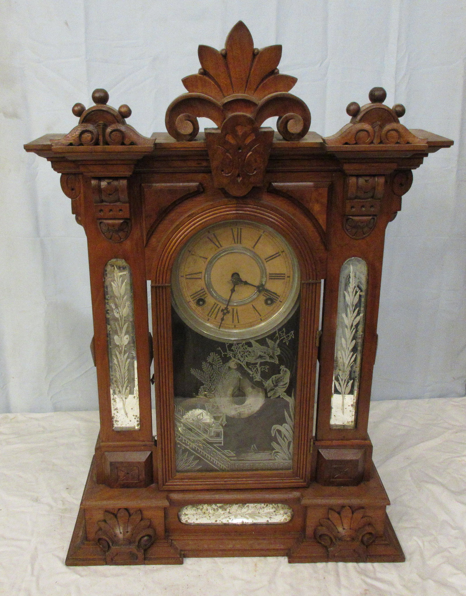 Fabulous antique Gilbert Amphion Mirror side clock: Fabulous antique Gilbert Amphion Mirror side clock. Walnut case and running at time of listing. Carved crest with etched mirrors on sides and base. Birds and foliage stenciled on glass. In good origin
