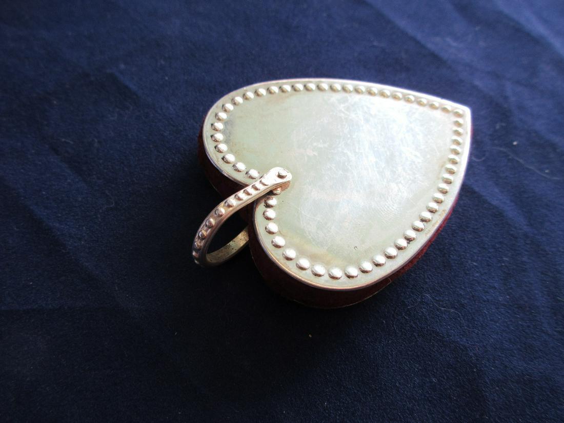 Unusual sterling heart shape pin cushion: Unusual sterling heart shape pin cushion. In good original as found condition. Beautiful colors with great quality and detail. Measures 2 ½ inches tall including loop.