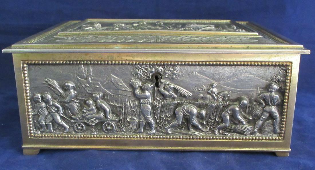 Magnificent heavily decorated large lidded box: Magnificent heavily decorated large lidded box. Great 3 dimensional designs on all sides. Brass with silver guilting panels. Measures 7 ¾ inches wide and 3 inches tall and 6 ¼ inches dee