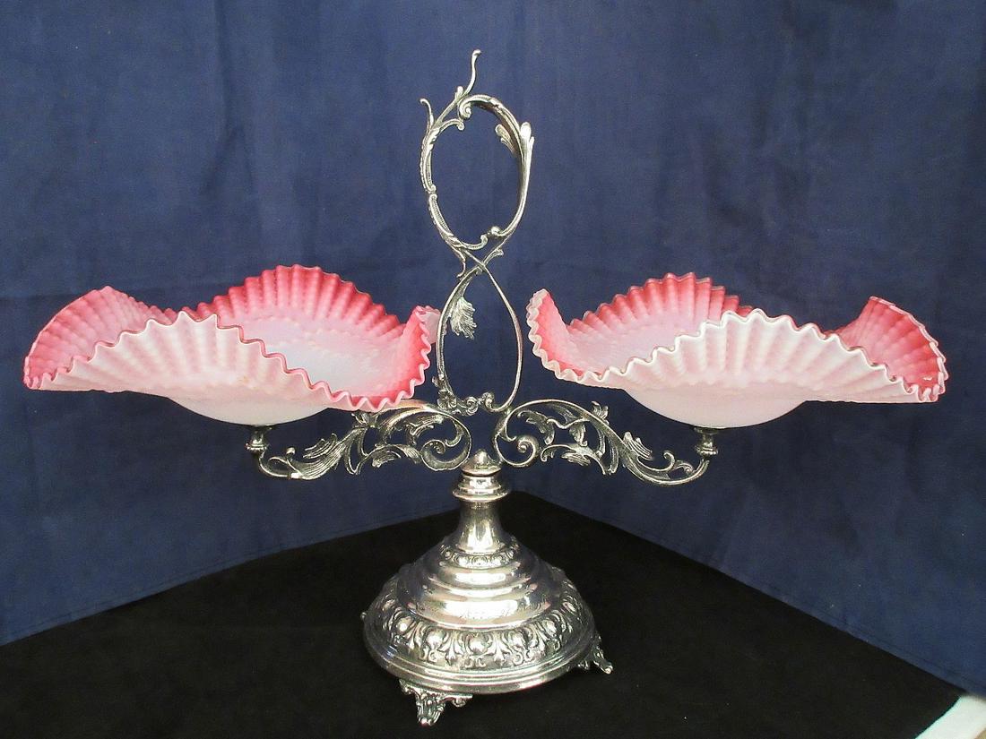 Victorian art glass brides basket dated 1877.: Victorian art glass brides basket dated 1877. Double Pink satin art glass bowls measuring 8 inches across and 13 ¾ inches tall. Total width is 17 ½ inches. In good original as found condition. Beaut