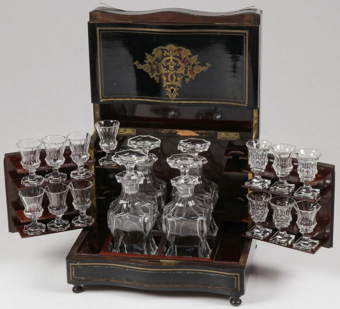GRAND FRENCH BOULLE TANTALUS SET, 19TH C: GRAND FRENCH BOULLE TANTALUS SET, 19TH C. resting on four bun-feet, opening to reveal four decanters with conforming stoppers in fitted compartments, and the swing-out doors with twelve matching cordi