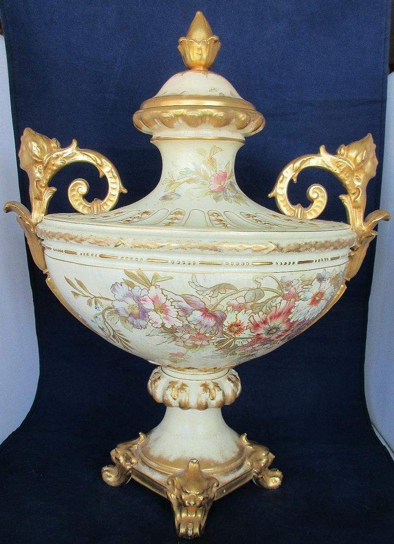 Large Royal Bonn dated 1883 Germany covered urn-vase: Large Royal Bonn Dated 1883. It would seem that this item is from 1890 to 1920 Germany covered urn-vase with ladies heads on handles and lion head feet. Measures 16" t. x 12" w. In good as found condi
