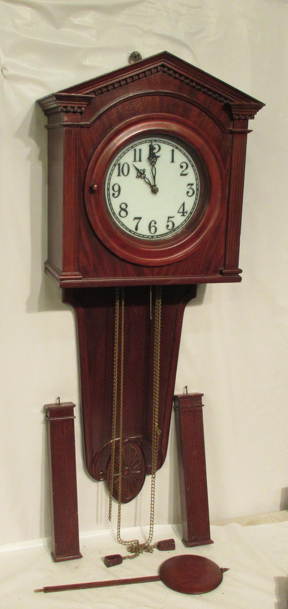 Rare Waterbury 2 Weight wall clock: Rare Waterbury 2 Weight wall clock. Circa 1900. Two fancy wood lead filled weights. Crotch mahogany case. Milk glass dial. Filled with lead. Original finish. Great original wood pendulum. . In good or