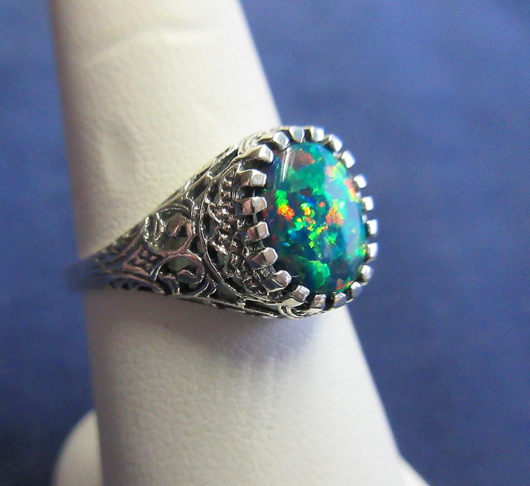 Beautiful red fire opal filigree sterling silver ring: Beautiful red fire opal filigree sterling silver ring. Apx 2 ½ ct. Size 8. In good as found condition with great quality and detail