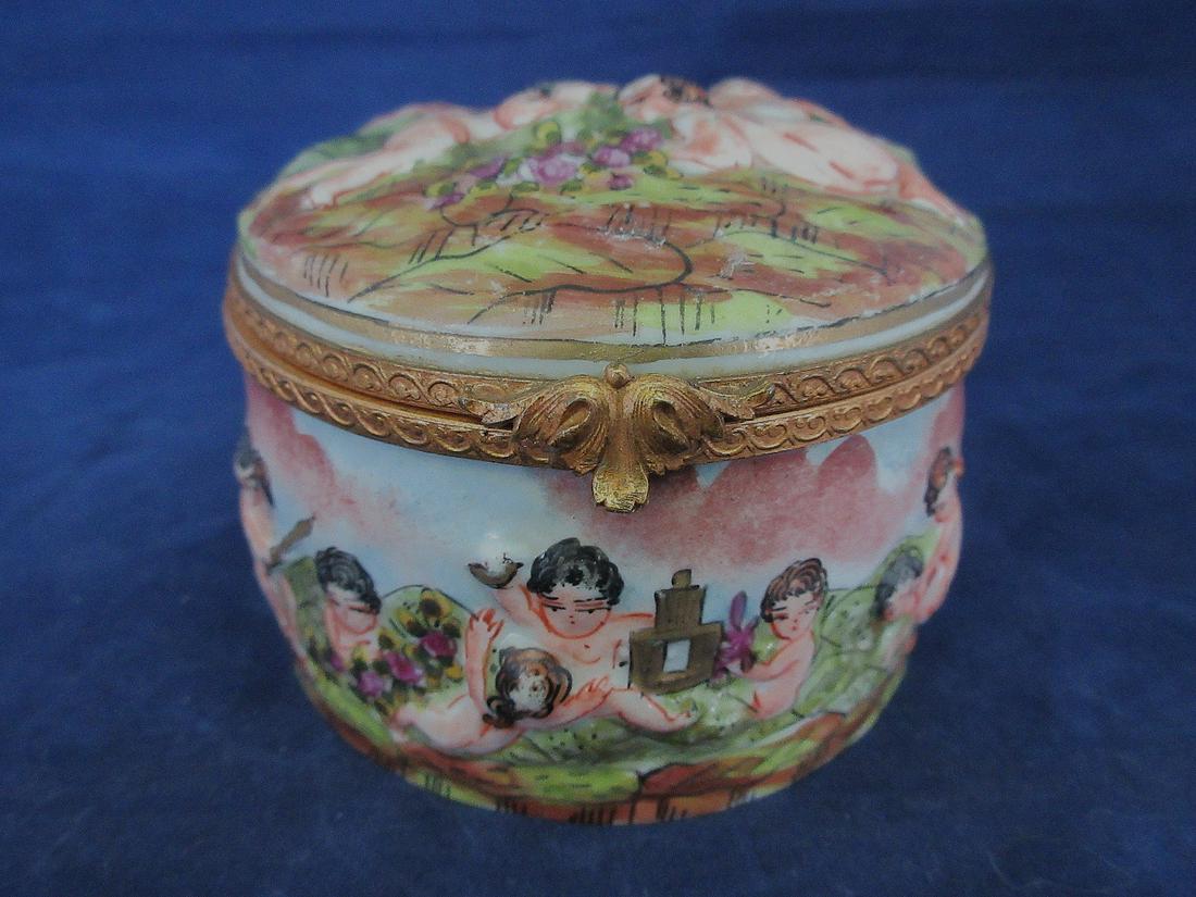 Delightful capodimonte covered jewelry box: Delightful capodimonte covered jewelry box. With elaborate decoration. Signed on bottom. Measures 3 â€œwide by 2 1/4 inches tall. In good as found condition with beautiful colors and great quality
