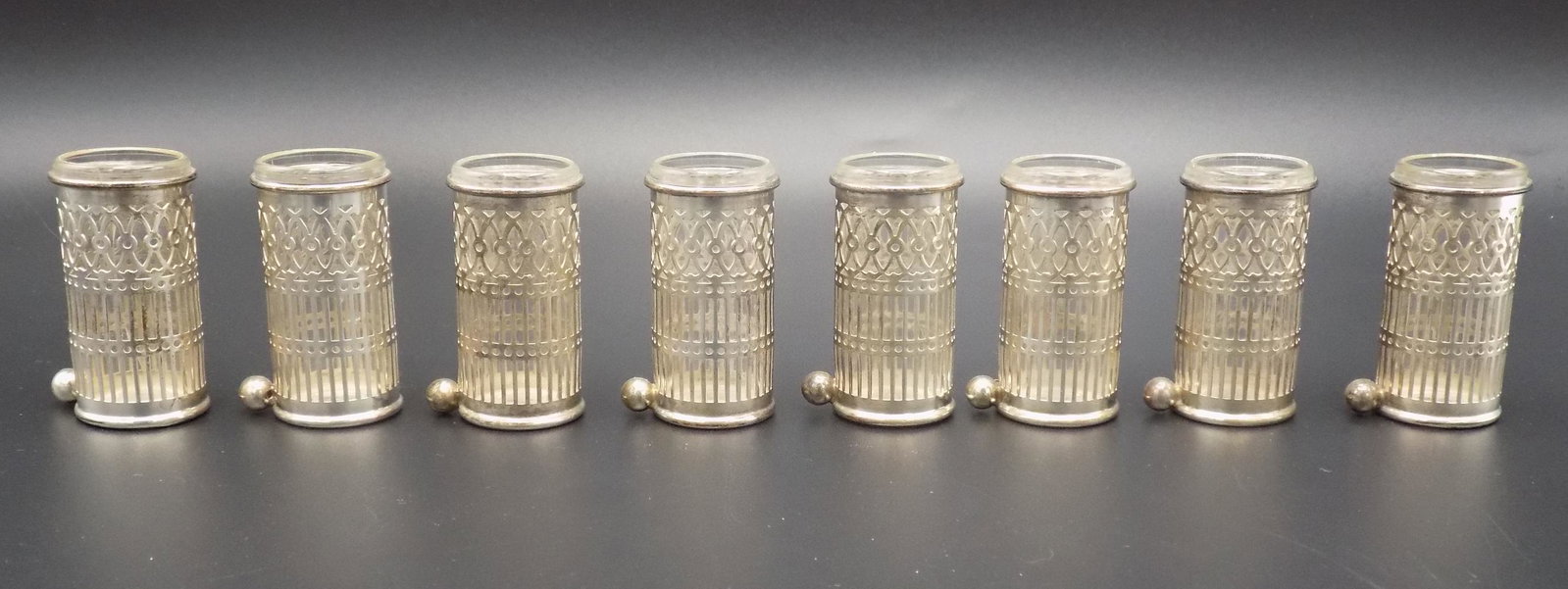 Onate set of 8 Sterling shot glasses.: Onate set of 8 Sterling shot glasses. IN GOOD ORIGINAL AS FOUND CONDITION. Beautiful colors with Great quality and detail. Plastic inserts. Measure 1 7/8 inches tall