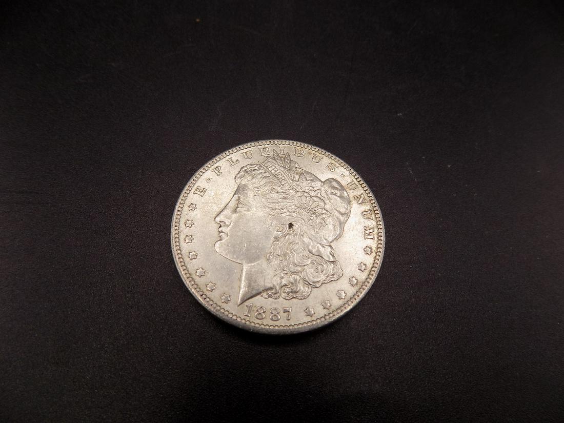 Uncirculated 1887 O Morgan silver dollar (1 of 2)