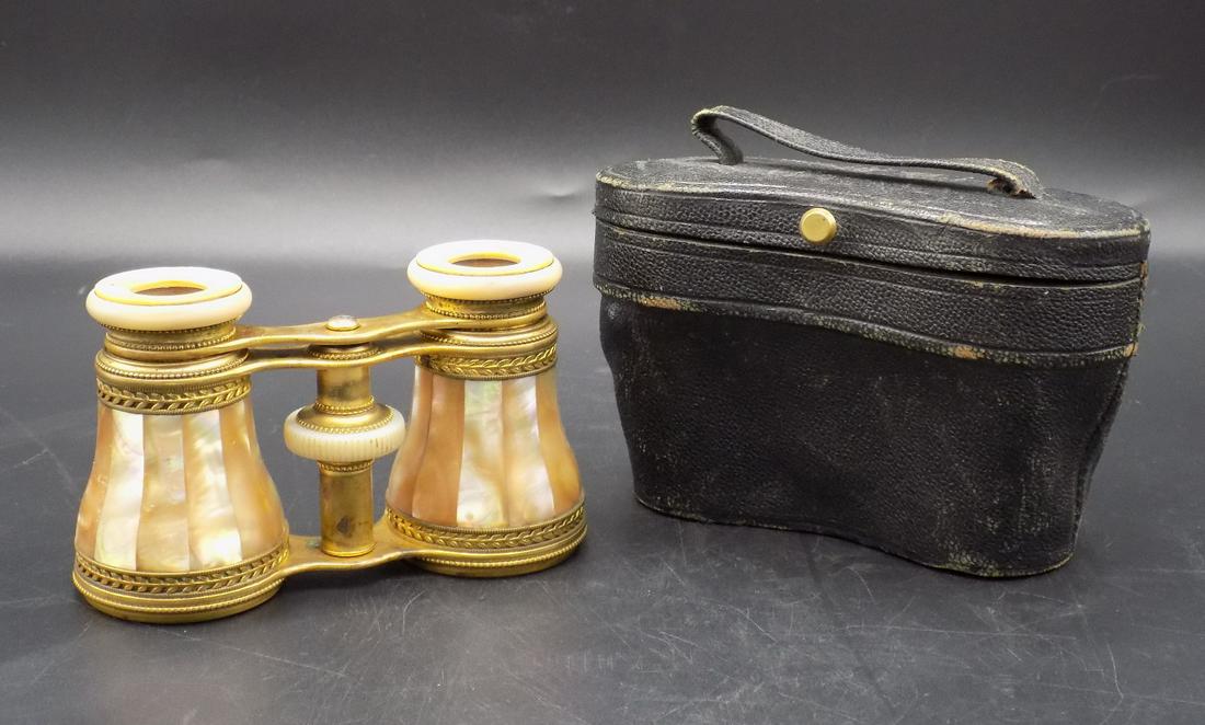 Delightful vintage French mother of pearl opera glasses: Delightful vintage French mother of pearl opera glasses with case. Marked around lens as shown in photo. Lenses nice and clean. Easily adjustable. Glasses measure 4 ¼”w x 2 3/8” tall closed. Unat