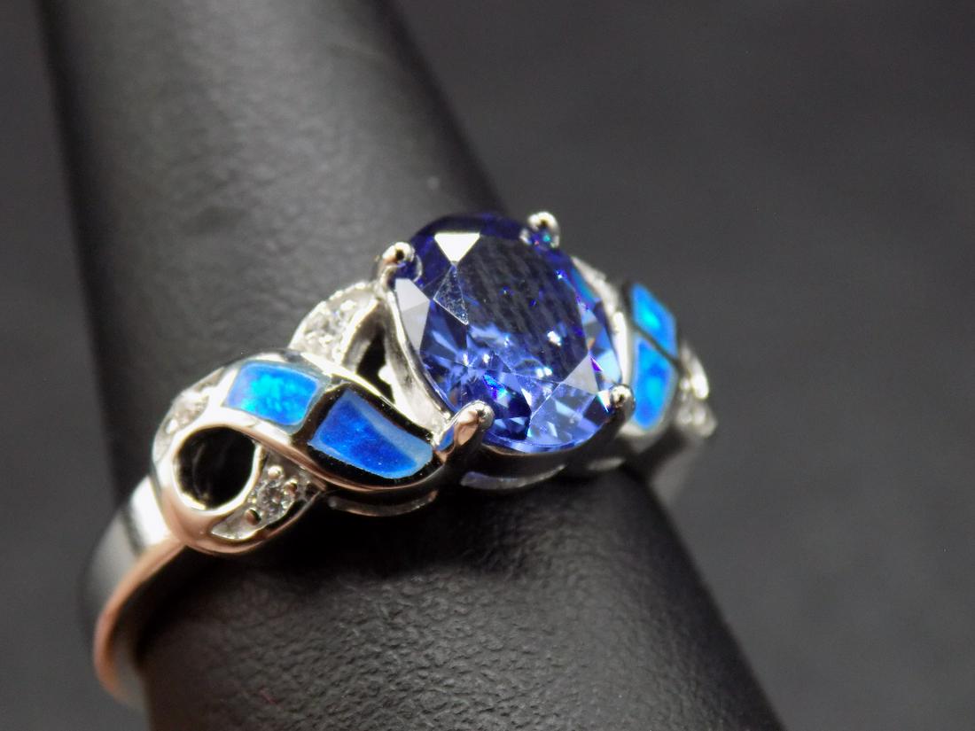 Beautiful tanzanite and blue fire opal .925 sterling: Beautiful tanzanite and blue fire opal .925 sterling silver ring. Lab created tanzanite. Size 9. In good original as found condition. Beautiful colors. Great quality and detail