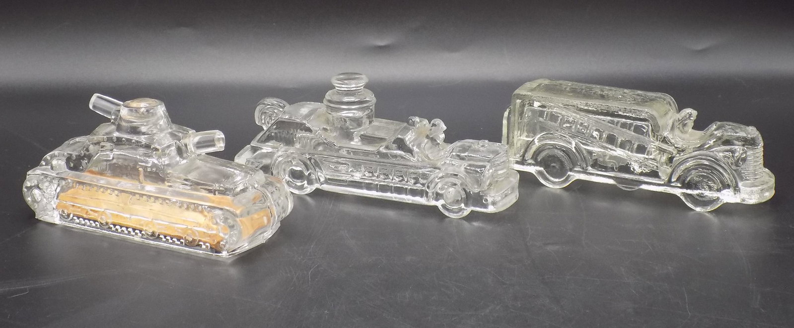 Three vintage glass candy containers: Three vintage glass candy containers. One has original bottom as shown in photo. In good original as found condition. Longest measures 5”.
