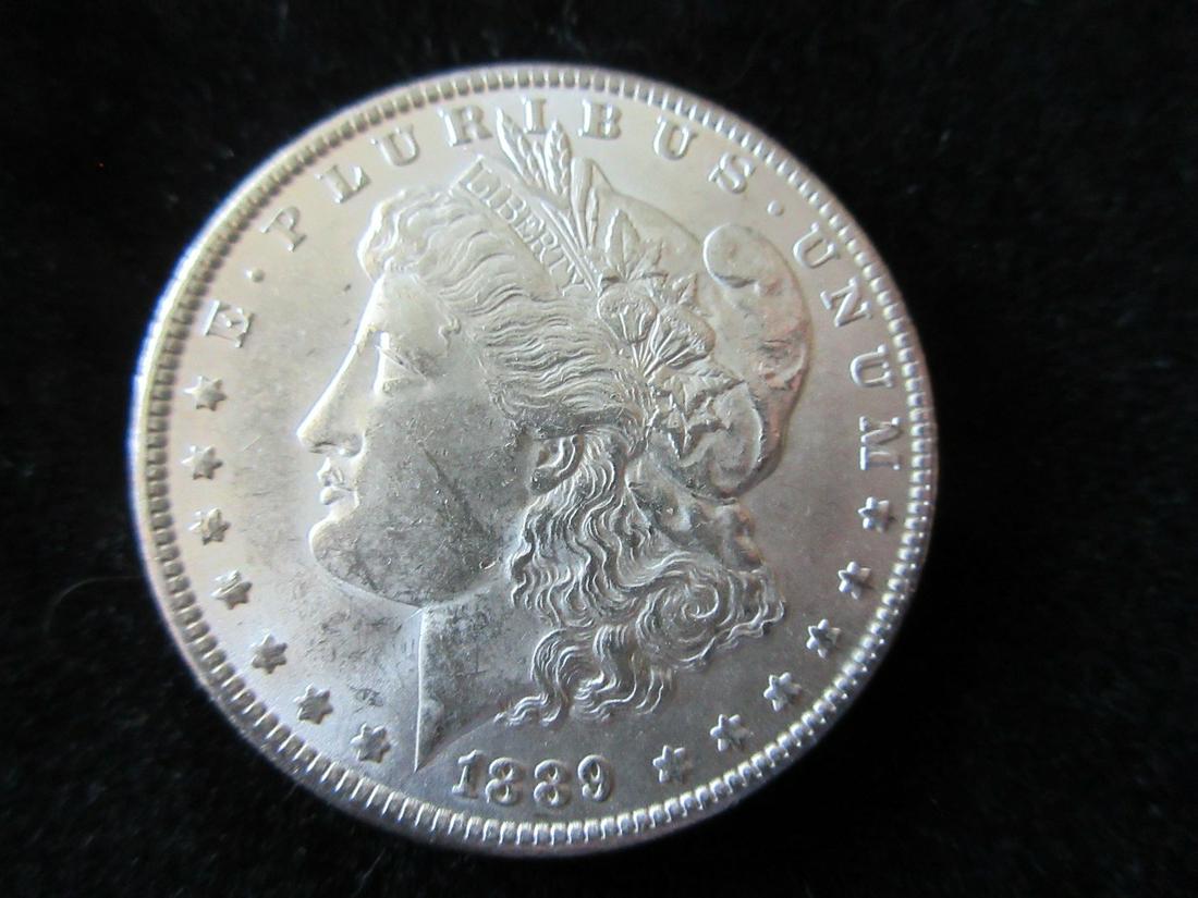 Uncirculated 1889 Morgan silver dollar: Uncirculated 1889 Morgan silver dollar. Please use photos to grade coin for yourself