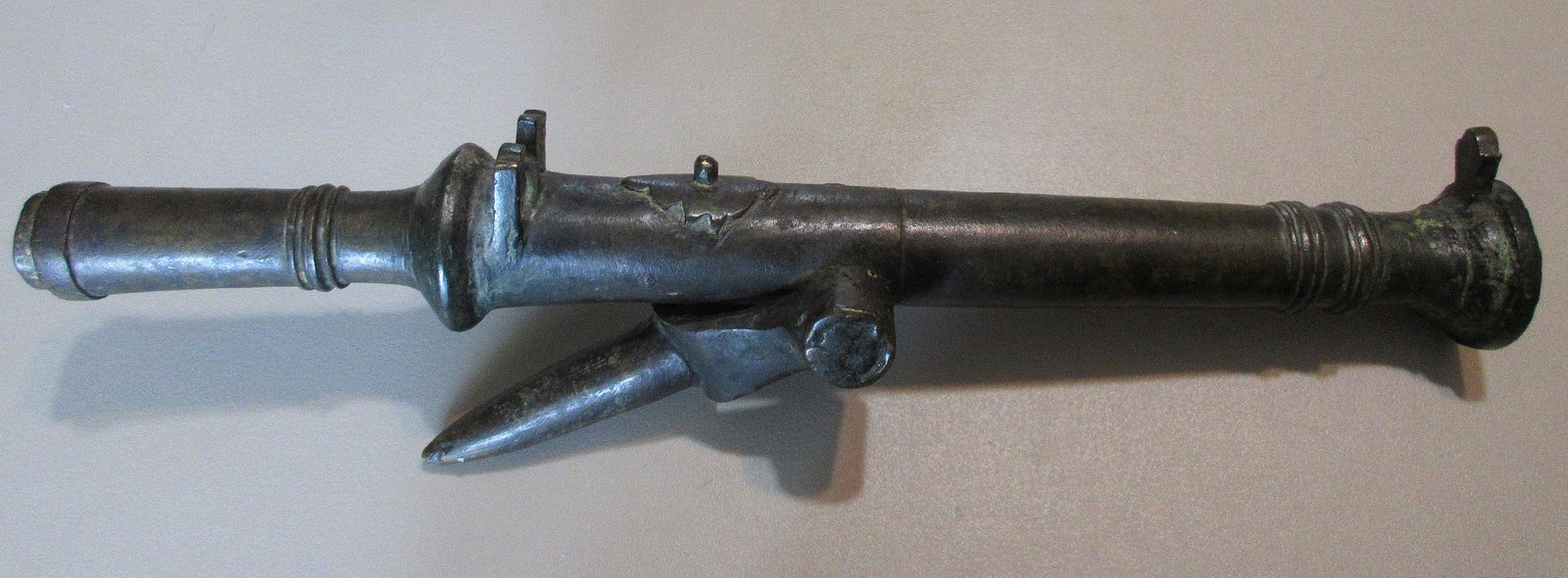 Bronze hand cannon. Circa. 1400’s-1500’s: Bronze hand cannon. Circa. 1400Â’s-1500Â’s. Also has attached mounting post to mount on ship. This is the first true firearm and successor of the fire lance. Oldest type of small arms as well as