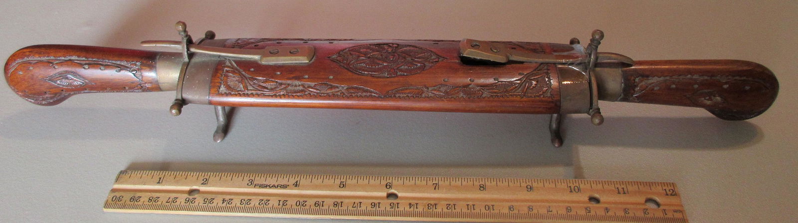 Heavily carved double knife carving set with case: Heavily carved double knife carving set with case. Appears to be mahogany. Guessing age last thirty to fifty years. In very good original as found condition. Screws loose on one release. Marked India