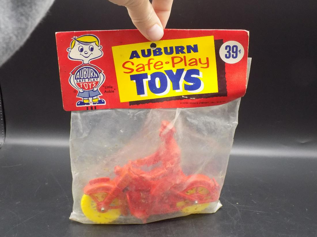 Vintage Auburn Rubber Motorcycle toy in Original: Vintage Auburn Rubber Motorcycle toy in Original package. Motorcycle looks brand new and never opened. Plastic bag holder has wear, please see photos. Auburn Safeplay toys. Motorcycle length measures 