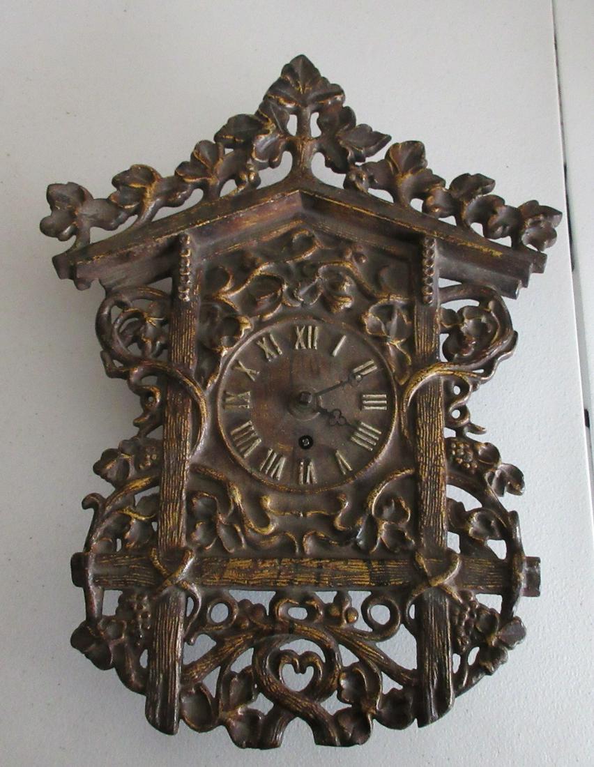 Fancy Victorian cast iron wall clock: Fancy Victorian cast iron wall clock. With clusters of grapes and vines hanging on sides. Running. In very good as found condition with original patina. Measures 15 ½” tall x 12” wide