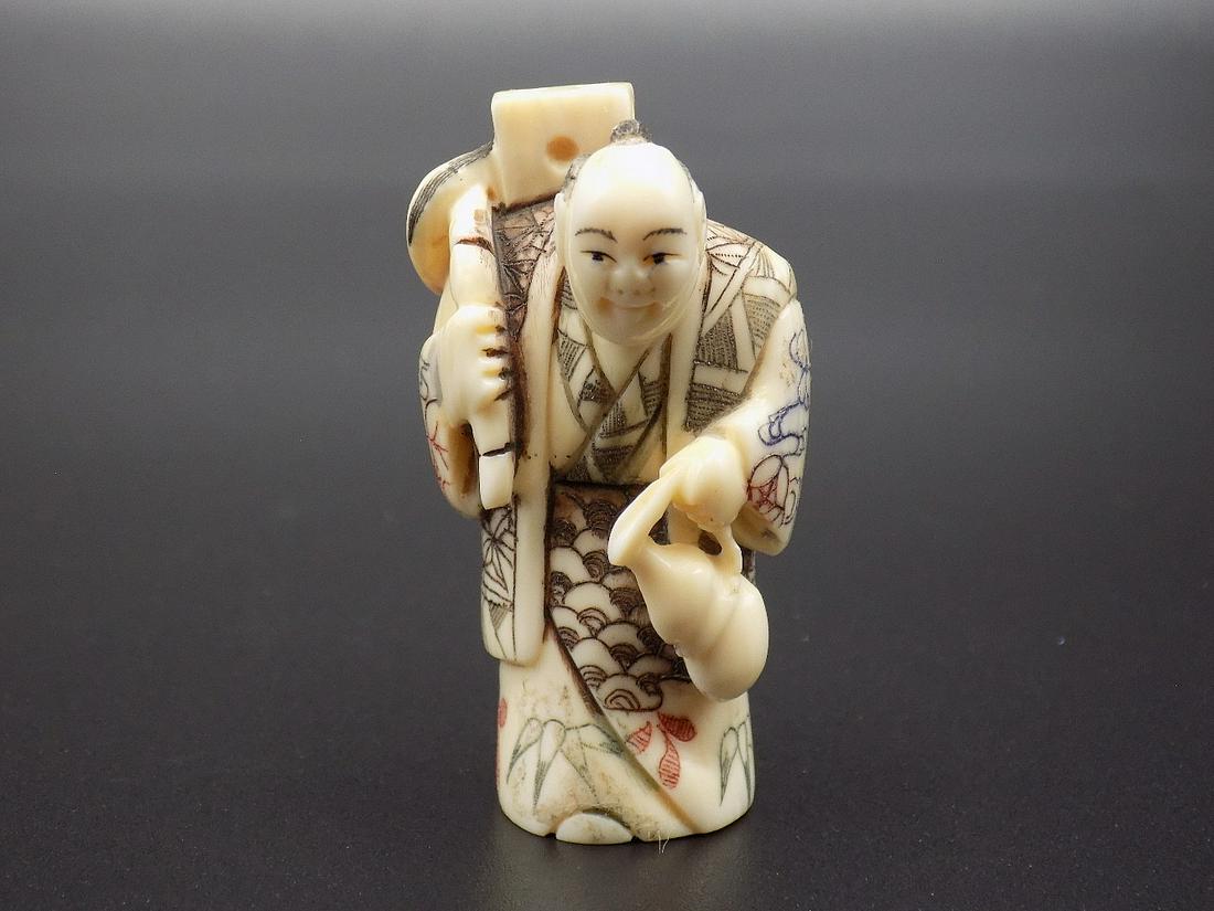 Vintage nicely carved Oriental Netsuke figure with mask: Vintage nicely carved Oriental Netsuke figure with mask. Artist signed on bottom as shown in photo. Appears to be Meiji period. Beautiful colors with great quality and detail. Measures 2” tall. 