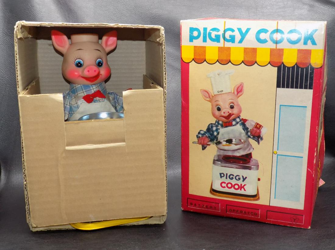 Vintage Piggy Cook tin battery toy in original box: Vintage Piggy Cook tin battery toy in original box. Near mint condition. Appears never to have been played with. toy lights up but does not work. Made in Japan. Beautiful colors. Box 10” x 6 &fr