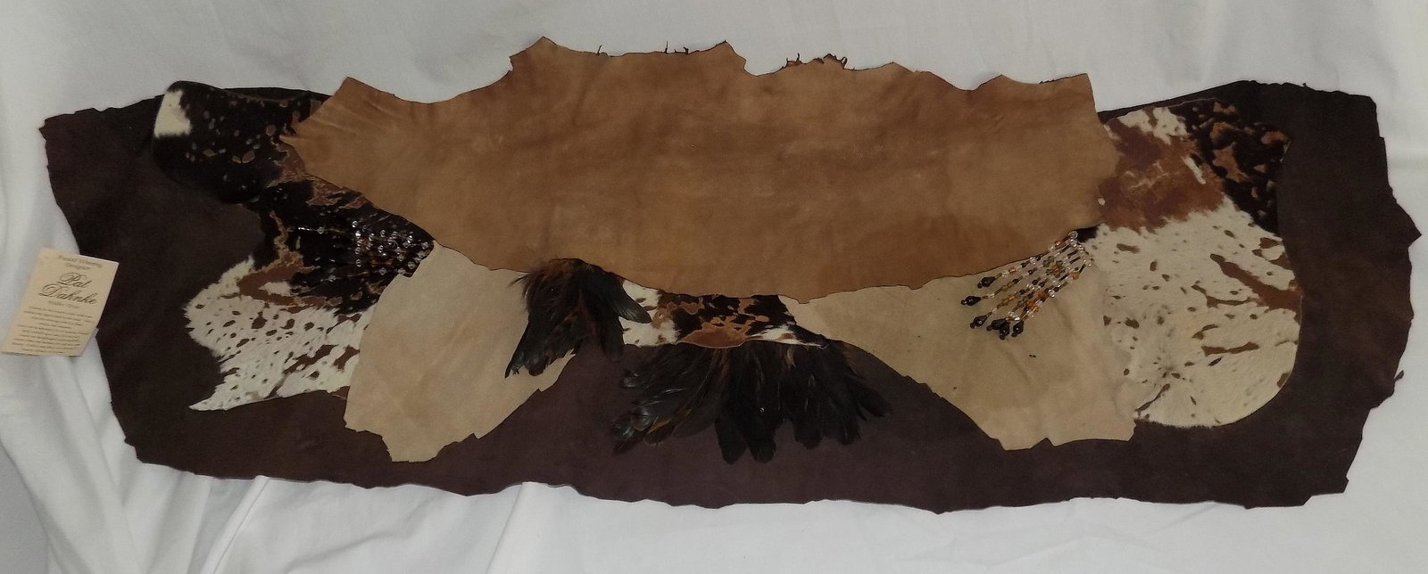 Award winning designer pat Dahnke leather Table topper brown.: Award winning designer pat Dahnke leather Table topper brown. Measures 34 inches by 14 ¾ inches