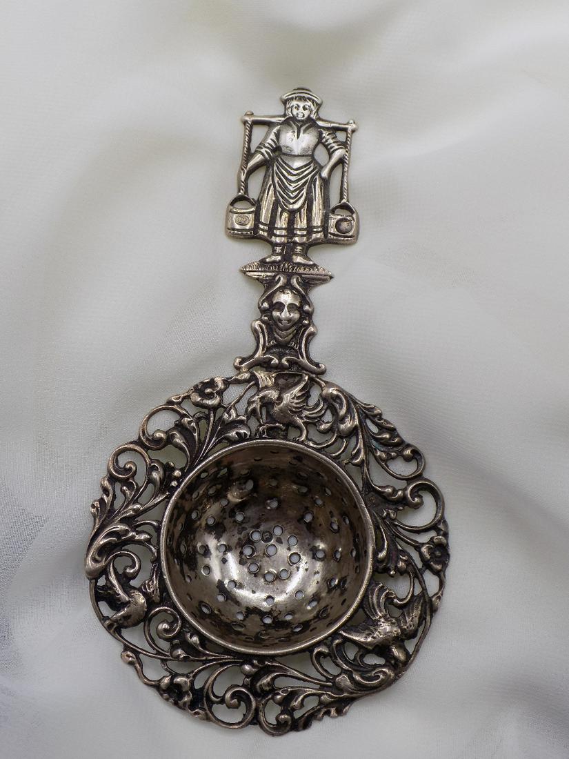 Ornate vintage .815 silver Dutch decorated tea strainer: Ornate vintage .815 silver Dutch decorated tea strainer. Marked on front of bucket .815 as shown in photo. Great quality and detail. In very good original as found condition. 34 grams. 4 ¾ inch