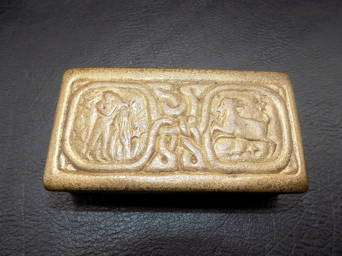 Lovely signed Tiffany bronze Zodiac stamp box: Lovely signed Tiffany bronze Zodiac stamp box . In very good as found condition. Great quality and detail. Measures 3 ½ inches by 1 ¾ and height is ¾ inches tall