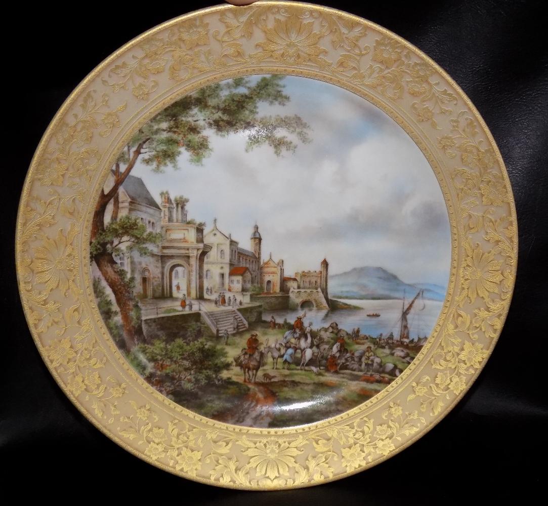 Gorgeous Decorated Scenic Charger: Gorgeous Decorated Scenic Charger. Kaiser W. Germany marked on back as shown in photo. Heavily decorated gold border. Castles and town scene along lake. Beautiful colors. Great quality and detail. 12 