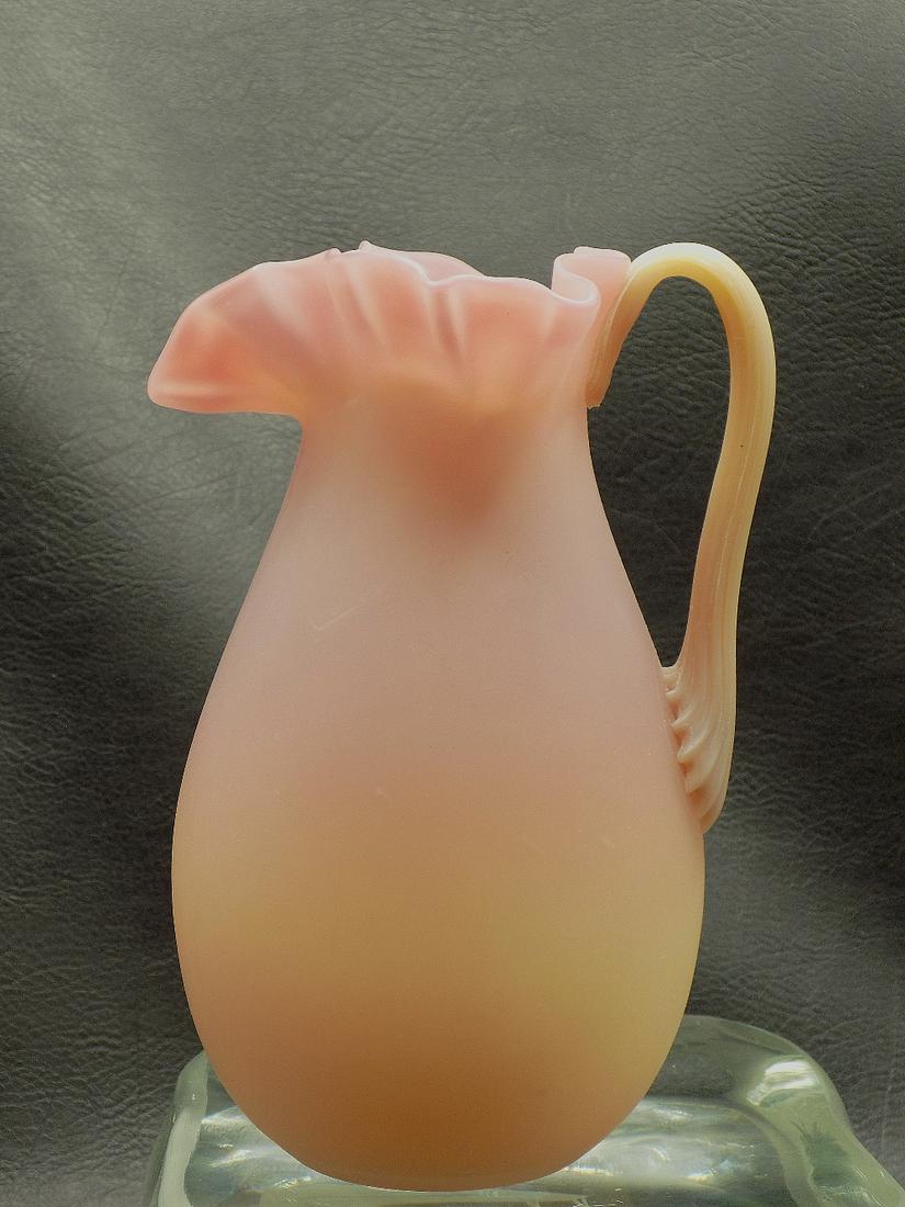 Vintage Burmese art glass pitcher. Applied handle: Vintage Burmese art glass pitcher. Applied handle. Beautiful colors. In very good original as found condition. 5 ¾ inches tall.