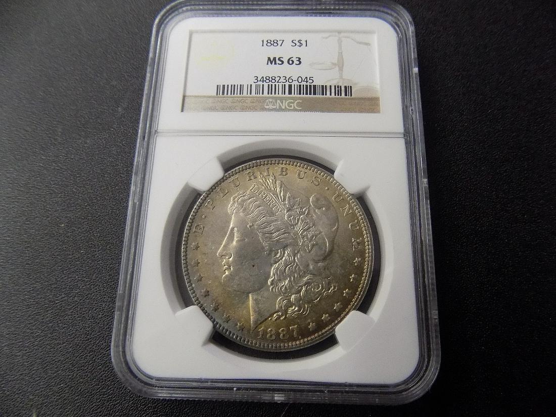 Graded MS63 NGC 1887 Morgan Silver Dollar.  With toning (1 of 3)