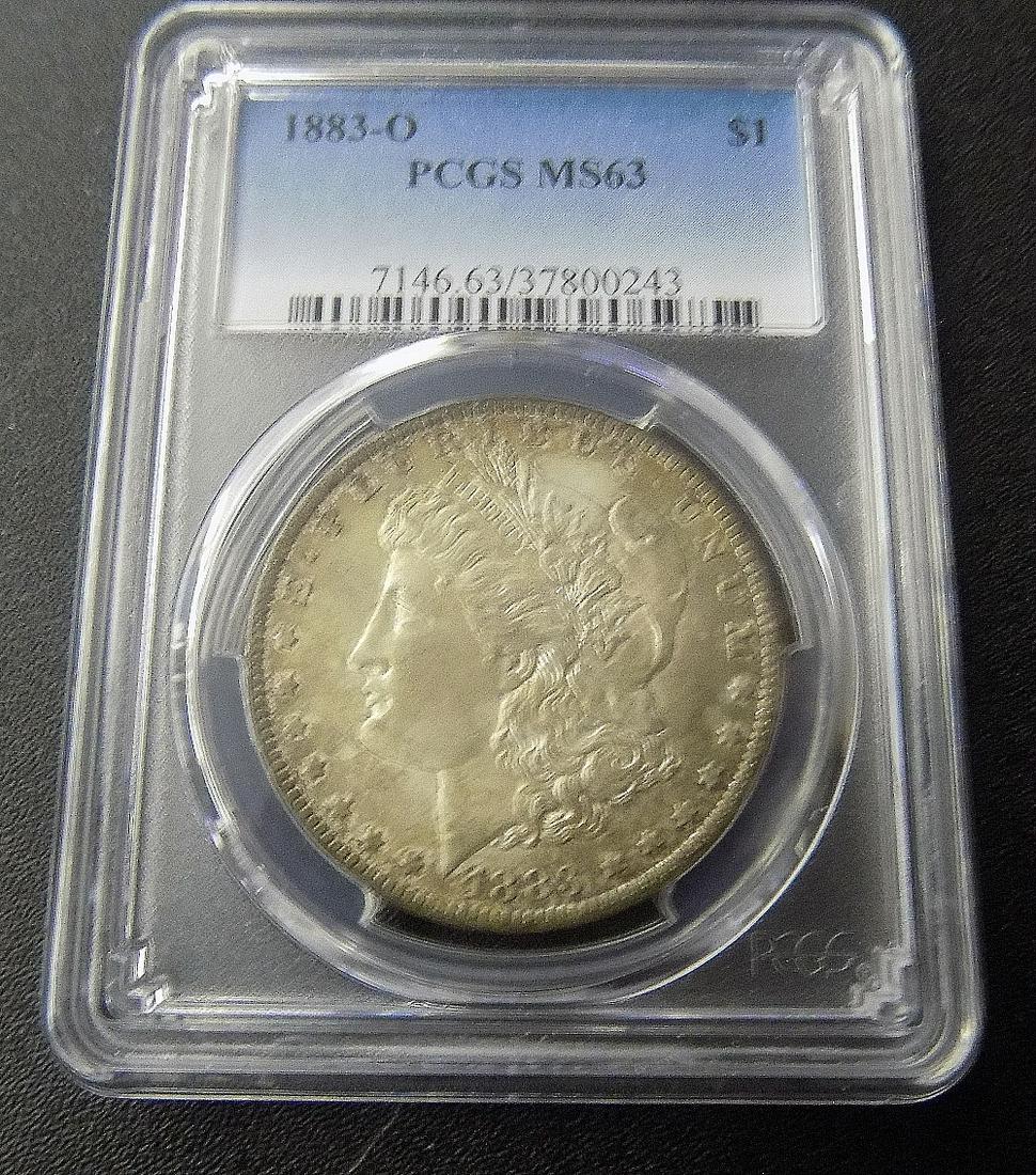 Graded PCGS MS63 1883 O  Morgan Silver Dollar.  Some toning (1 of 2)