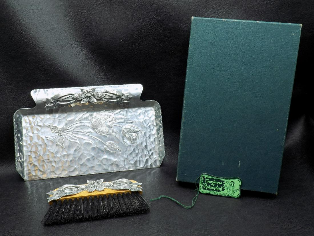Unusual vintage hammered aluminum crumb tray and brush in original box: Unusual vintage hammered aluminum crumb tray and brush in original box. Hand Made by Rodney Kent marked on back of tray Beautiful floral decoration. Dragonfly in tray. Looks never to have been used. T