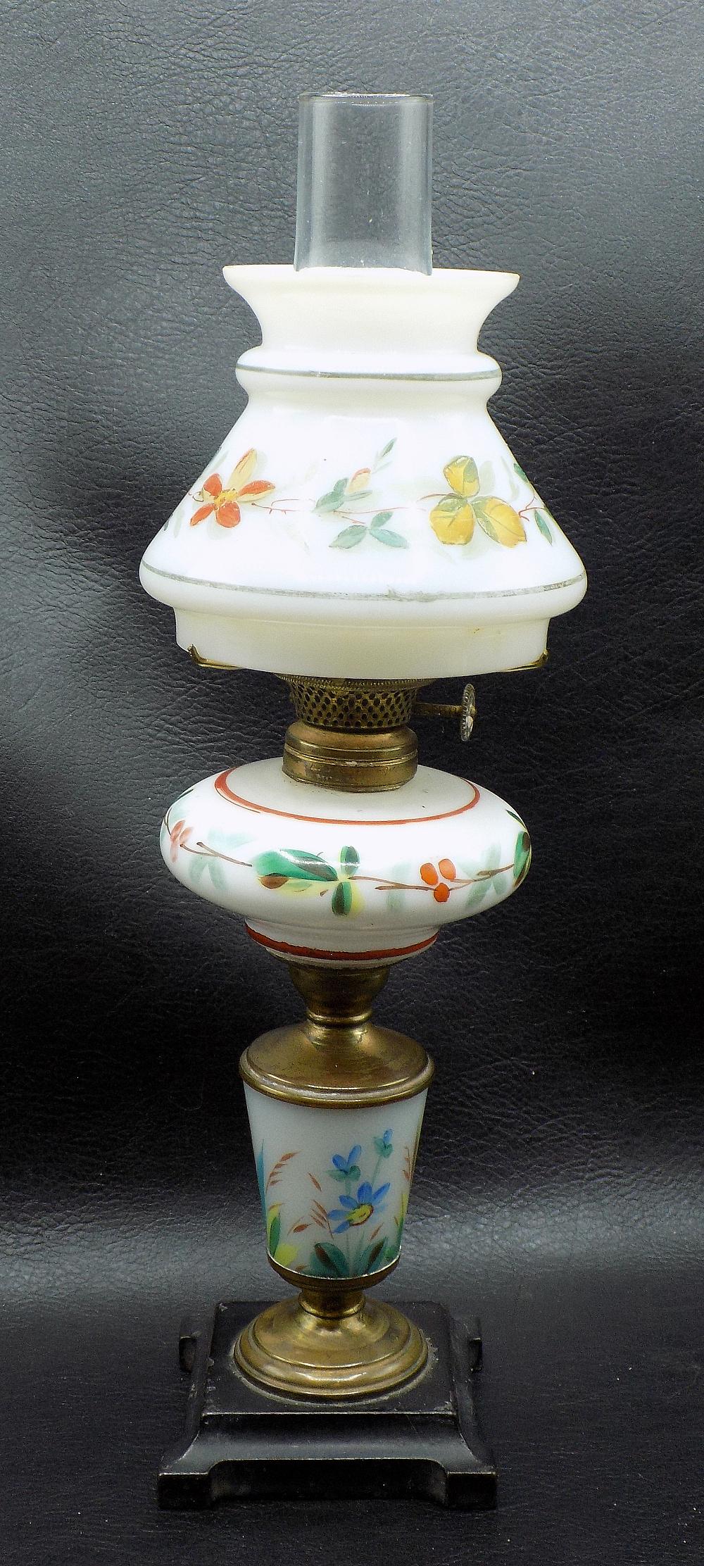 Rare antique miniature three tier kerosene lamp: Rare antique miniature three tier kerosene lamp. Hand painted. Cast iron base. Beautiful colors. Great quality and detail. Small fleabite chip on bottom of shade as shown in photo, normal from age and