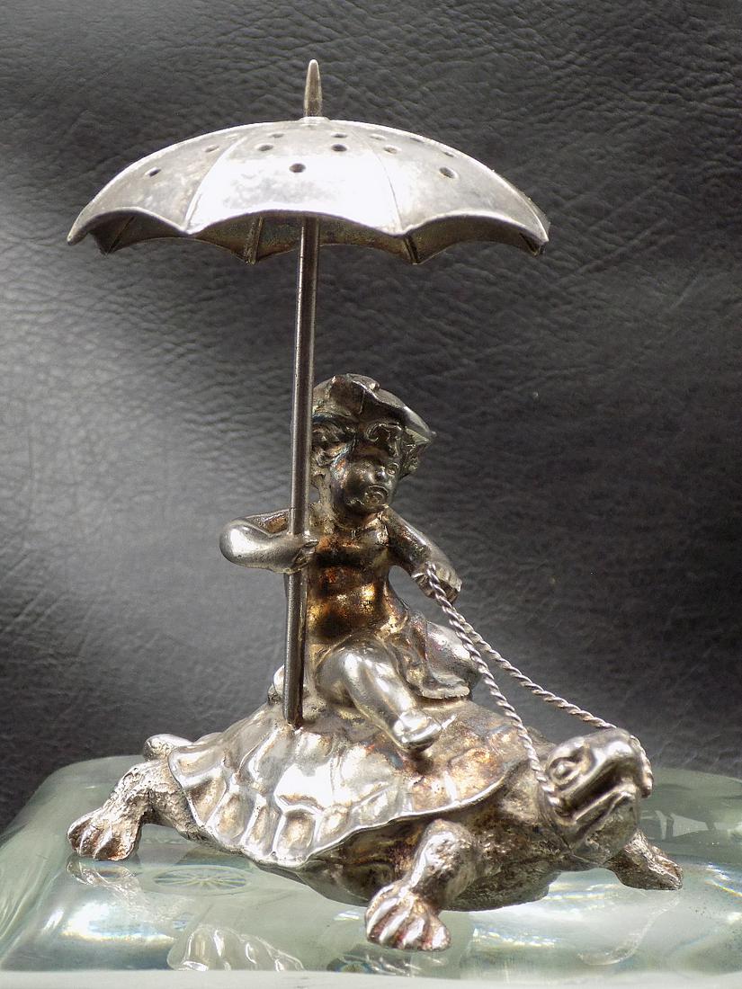 Rare Antique Pairpoint Company Cherub Putti on turtle toothpick holder: Rare Antique Pairpoint Company Cherub Putti on turtle toothpick holder. Umbrella holds toothpicks. Looks to have mark on inside of bottom and is very hard to see. Great quality and detail. In very goo