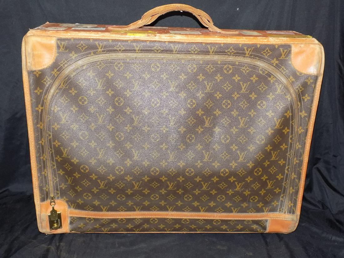 Vintage Louis Vuitton suitcase: Vintage Louis Vuitton suitcase. Shows character from well-traveled with airline stickers as shown in photos. Please see photos for condition. Zippers works well and has keys. Wear normal from travel. 