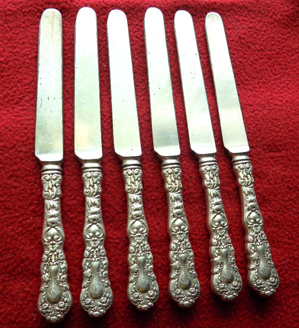 Six fancy sterling silver knives. Has monograms as shown in photo: Six fancy sterling silver knives. Has monograms as shown in photo. Marked sterling as shown in photo. Blade shows wear from use and age as shown in photos. 8 ½ inches long. 294 grams