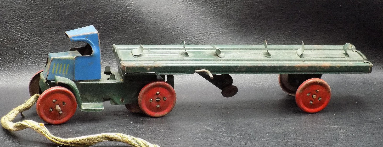 Vintage Marx tin truck and trailer: Vintage Marx tin truck and trailer. Marked on front of truck. Small pull rope added at some time. Shows wear normal from use and age. Total length 12 ¼ x 3 inches tall