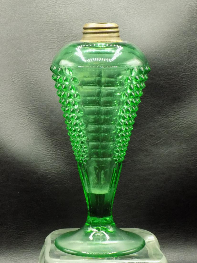 Antique green flint art glass whale oil lamp: Antique green flint art glass whale oil lamp. Three dimensional design in glass. Great quality and detail. In very good original as found condition. 8 5/8 inches tall x 3 ½ wide at base.