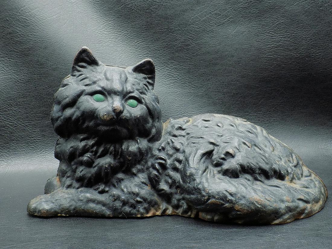 Charming vintage cast iron cat door stop: Charming vintage cast iron cat door stop. Great quality and detail. Original paint with minor wear normal from use and age. Has rusting on bottom as shown in photo. Could be Hubley. No maker markings.