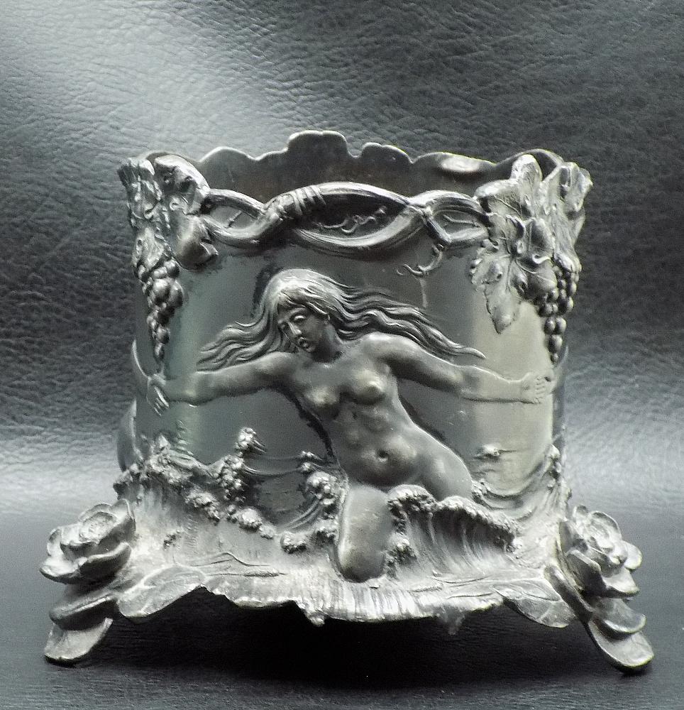 Fabulous antique silverplated wine bottle holder with nudes: Fabulous antique silverplated wine bottle holder with nudes. Three dimensional relief with nudes, grapes, and flowers. Marked on bottom as shown in photos. Great quality and detail. 4 inches tall x 3