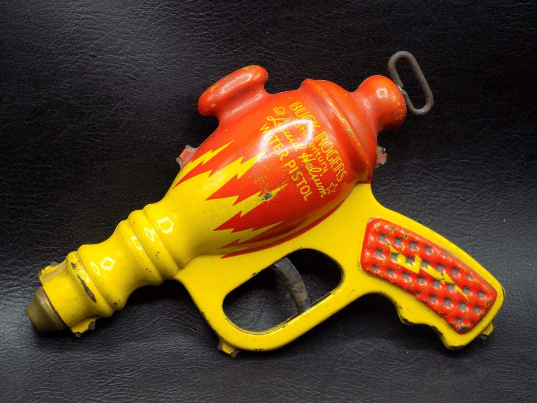 Vintage Buck Rogers tin space gun: Vintage Buck Rogers tin space gun. 25th Century Liquid Helium Water Pistol Daisy MFG Co. Great quality and detail Beautiful colors. Please see photos for light wear. 7 ½ long x 6 inches tall.