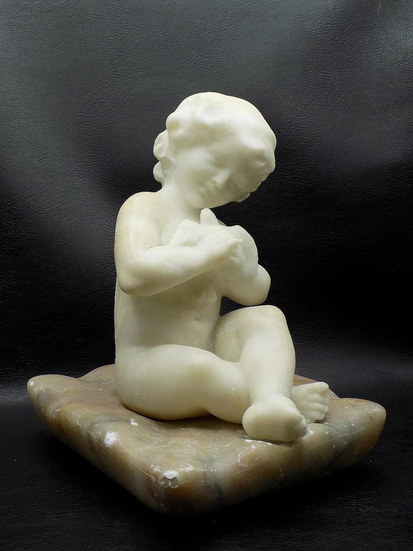 Antique carved marble figure of child holding a bird and sitting on a pillow (1 of 8)